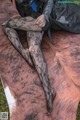 A woman sitting on top of a cowhide covered ground.