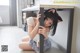 A woman sitting on the floor under a table.