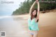 A woman in a bikini standing on a beach.