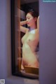 A naked woman standing in front of a mirror.