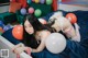 A woman laying on top of a bed with balloons.