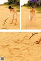 A woman standing on a sandy beach holding a stick.