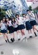 A group of young women in school uniforms posing for a picture.