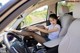 A woman sitting in the driver's seat of a car.