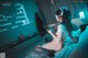 A woman sitting on a bed playing a video game.